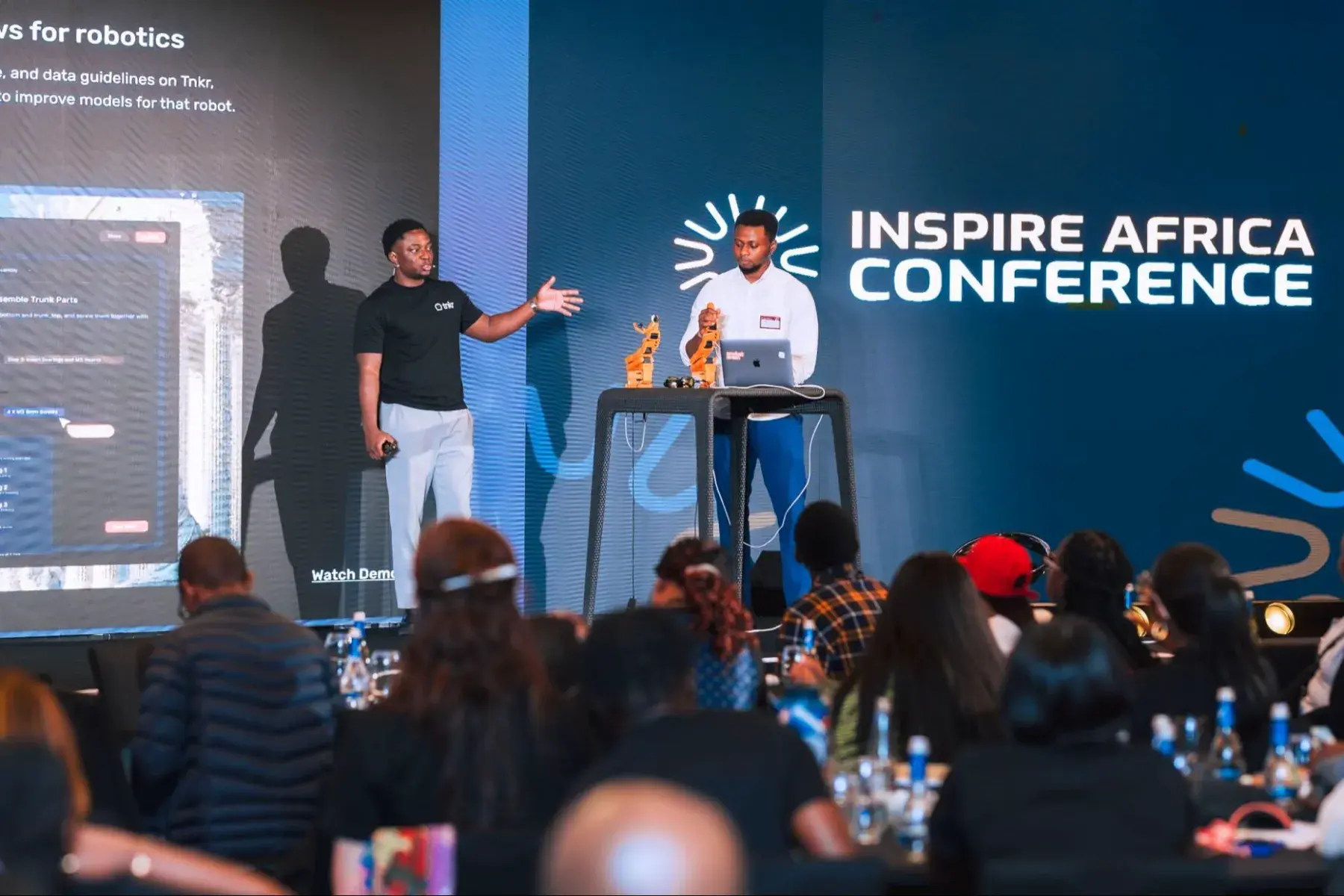 A speaker on stage at the Inspire Africa Conference
